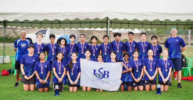 Members of the ISB U13 FOBISIA Team pose together after an outstanding performance at the 2025 FOBISIA Games. The team won an impressive 79 medals in total, with every student earning at least one medal.