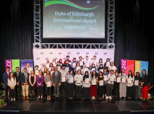 ISB students awarded Gold, Silver, and Bronze Duke of Edinburgh International Awards pose with Dr. Peter Jones, Head of ISB Secondary, along with teachers and staff, during the DofE International Award Ceremony at the ISB Theatre on April 15, 2025.