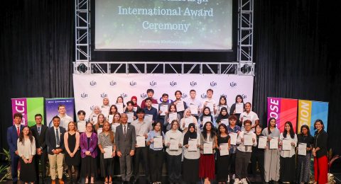 ISB students awarded Gold, Silver, and Bronze Duke of Edinburgh International Awards pose with Dr. Peter Jones, Head of ISB Secondary, along with teachers and staff, during the DofE International Award Ceremony at the ISB Theatre on April 15, 2025.